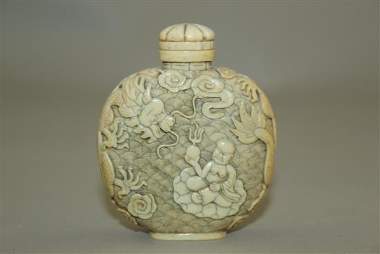 A Chinese ivory dragon and luohan snuff bottle, 1800-1850, 6.2cm